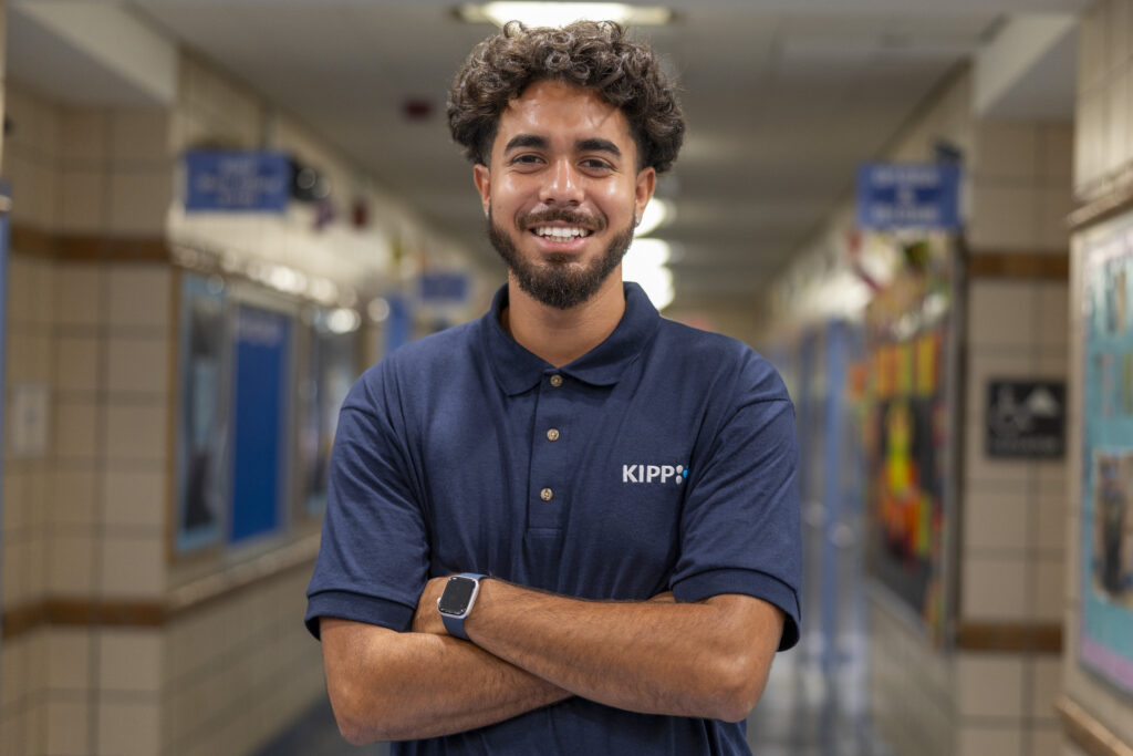 A KIPP NYC staff member in a school hallway